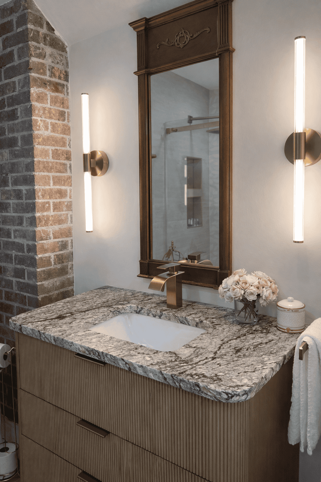 Upscale bed and breakfast bathroom near Charlotte NC with marble vanity, brass fixtures, and elegant lighting at Laurel Haven Estate vineyard