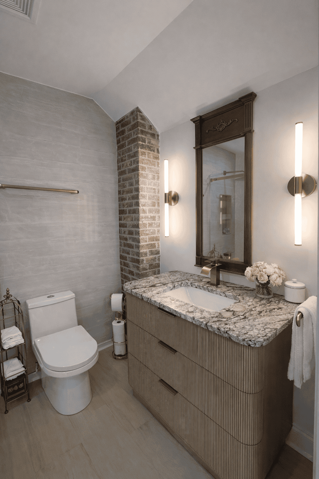 This elegant bathroom at Laurel Haven Estate Vineyard and Winery in Lancaster, South Carolina blends modern luxury with historic charm, featuring a marble vanity, brass fixtures, and a striking exposed brick accent wall. Designed with upscale finishes and thoughtful details, this boutique bed and breakfast bathroom offers a refined and relaxing experience for wedding guests and overnight stays near Charlotte, NC.