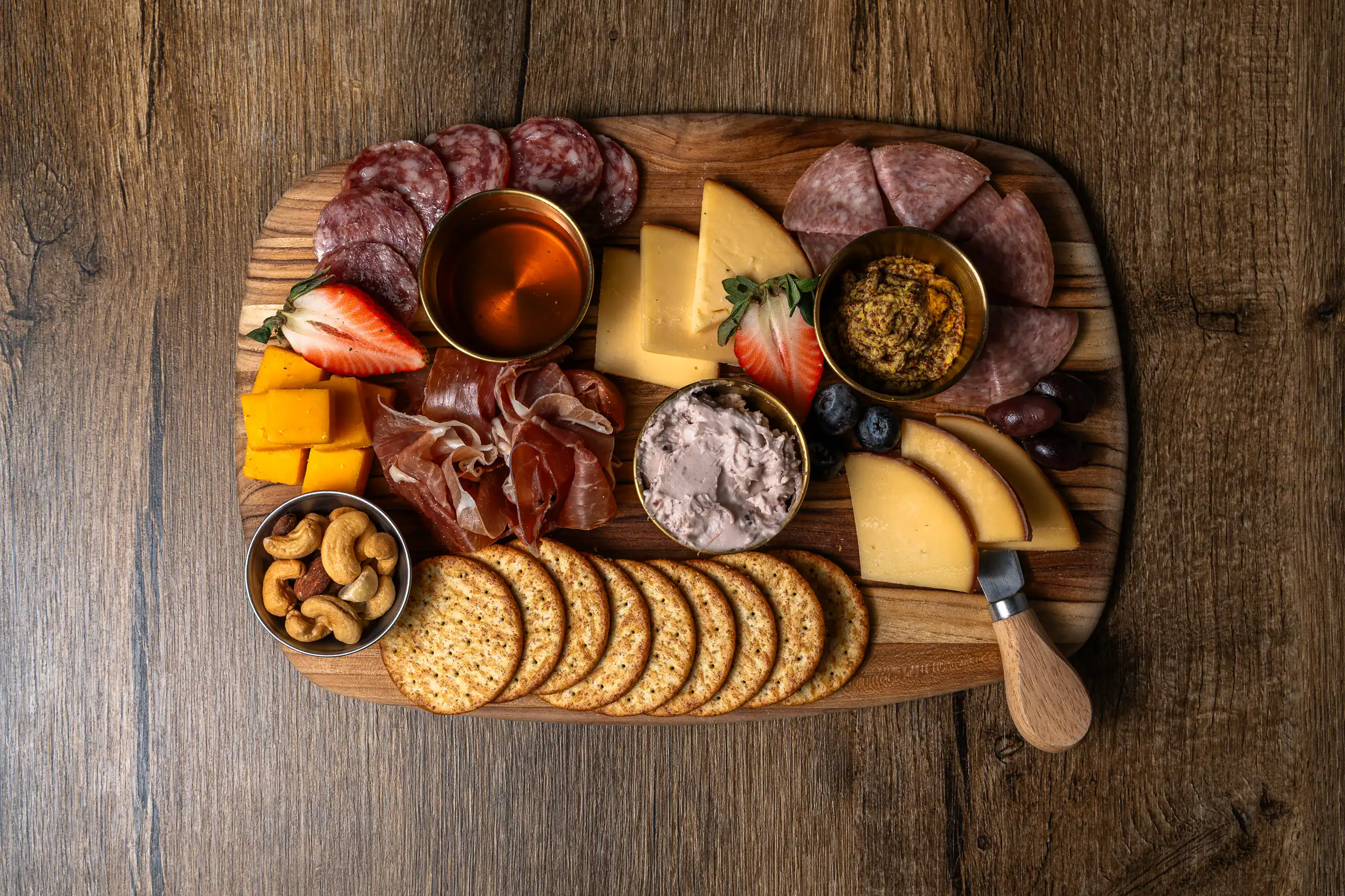 Intimate vineyard wine tasting setup with gourmet cheese and scenic views