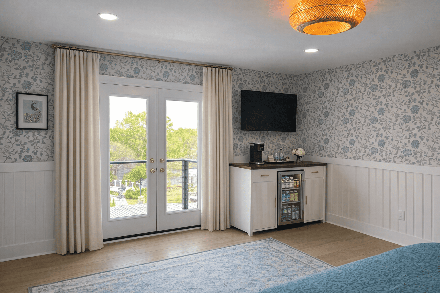 Jessamine Suite at Laurel Haven Estate in Lancaster SC featuring French doors to Romeo and Juliet balcony overlooking pond and vineyard, with curtains, in-room bar, mini fridge, and elegant decor